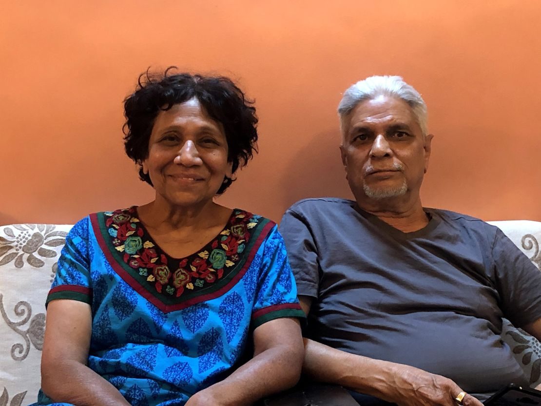 A retired Indian couple sitting together at home